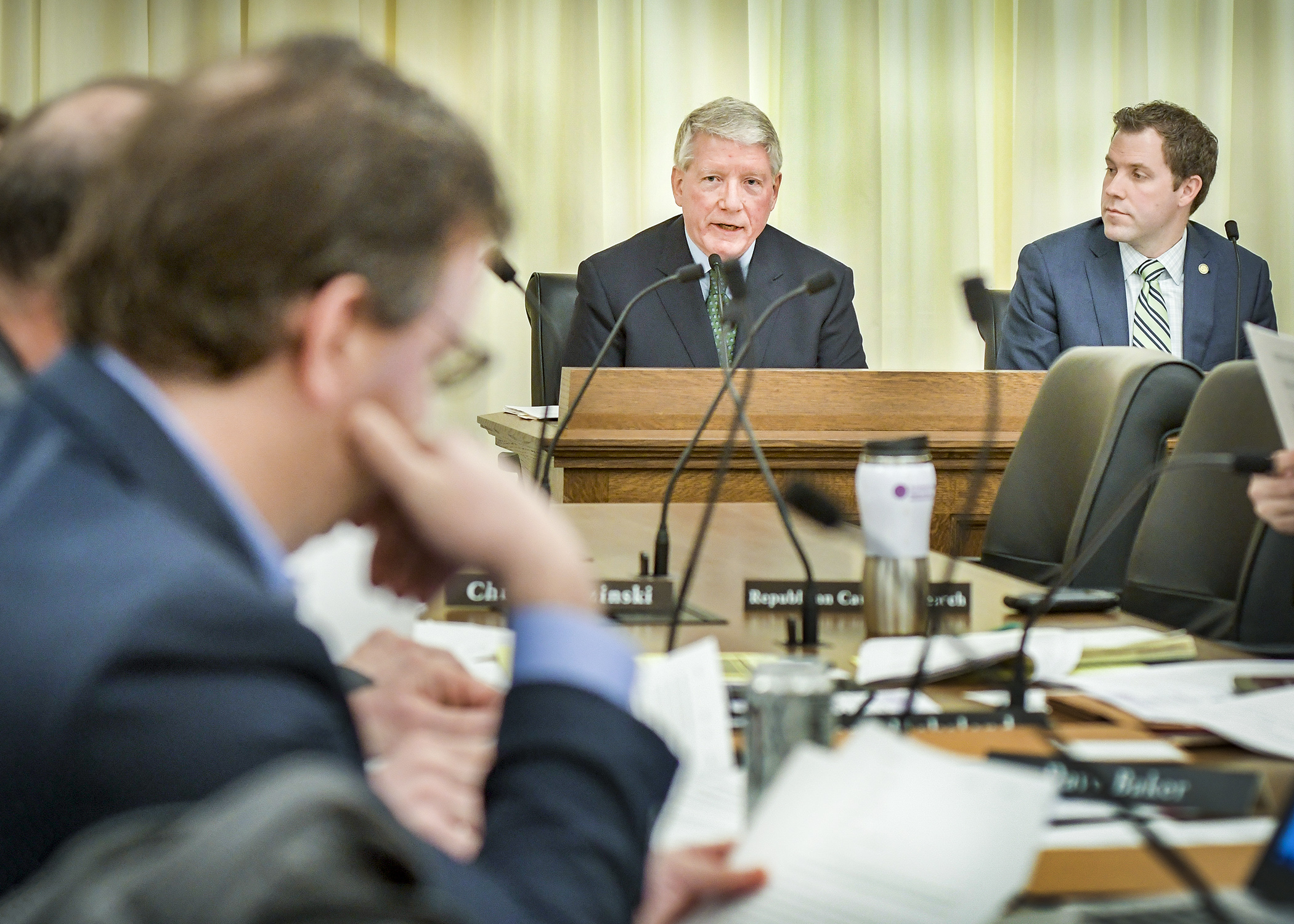 Commerce Commissioner Steve Kelley answers questions from a member of the House Energy and Climate Finance and Policy Division March 12 during discussion of a bill sponsored by Rep. Jamie Long, right, to establish a Clean Energy First Act. Photo by Andrew VonBank